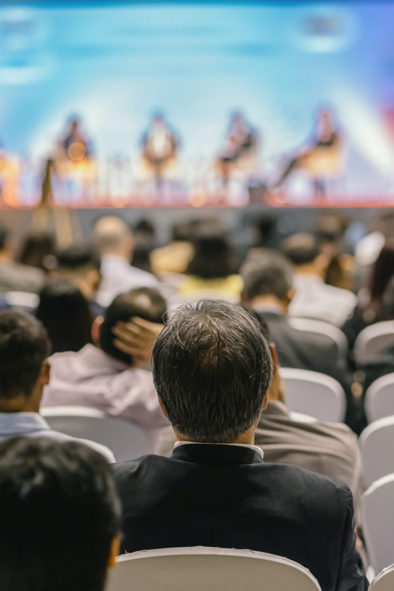 rear-view-of-audience-listening-speakers-on-the-stage-in-the-conference-hall-or-seminar-meeting.jpg